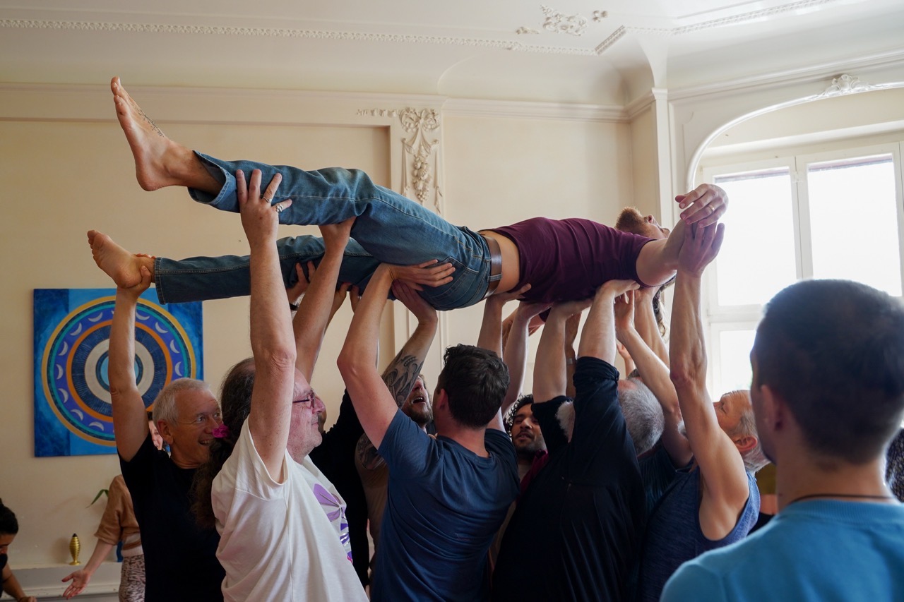 A participant held aloft by the Love, Relationships and You circle